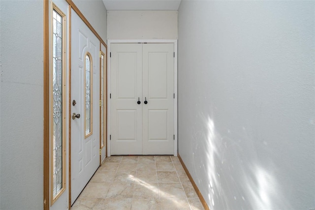 hall featuring light tile patterned floors