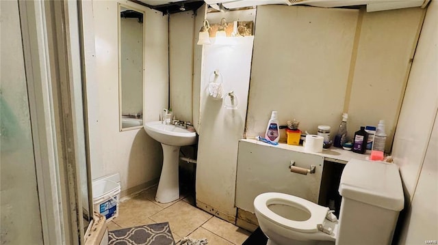 bathroom featuring tile patterned floors, toilet, and sink