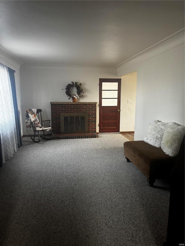 sitting room featuring crown molding, plenty of natural light, carpet, and a brick fireplace