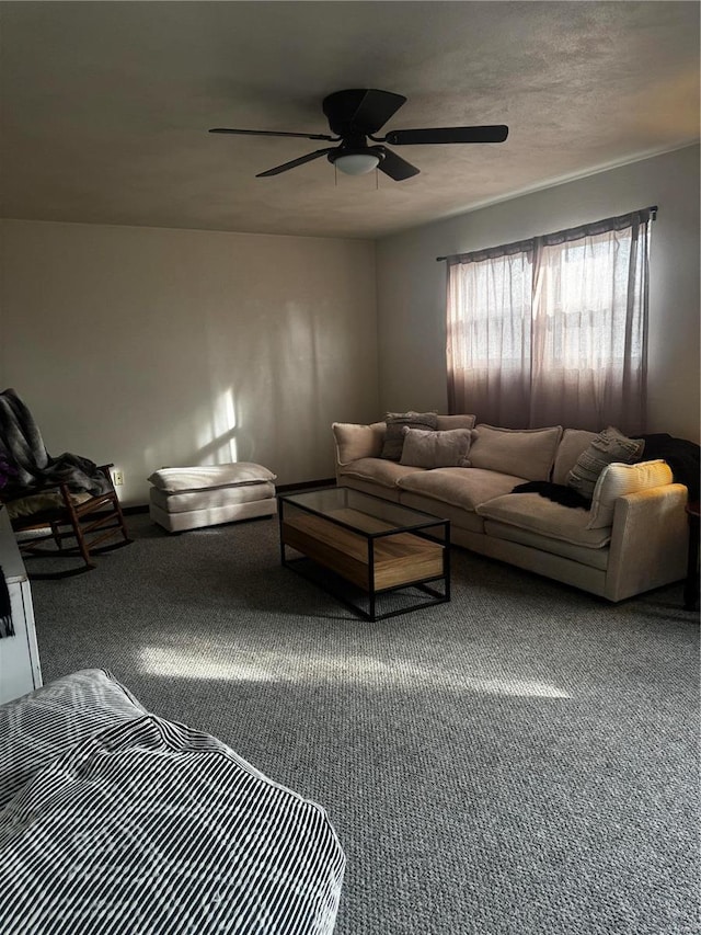 living room with ceiling fan, carpet, and a textured ceiling