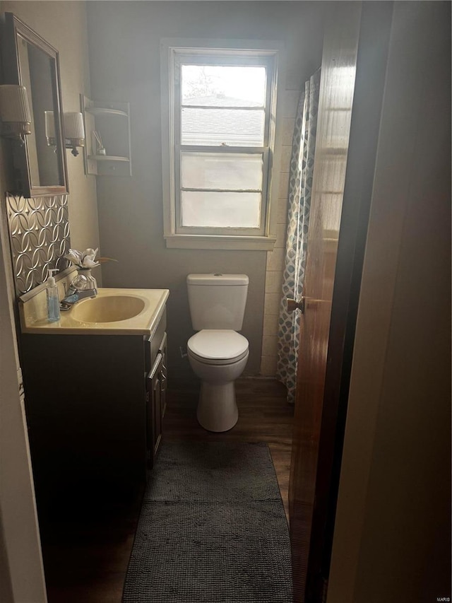 bathroom with vanity, wood-type flooring, and toilet