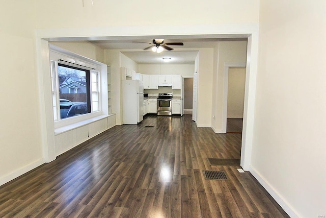 unfurnished living room with ceiling fan and dark hardwood / wood-style floors