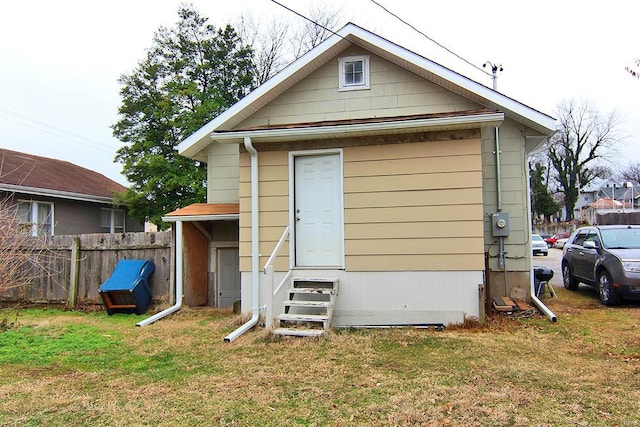 rear view of property featuring a yard