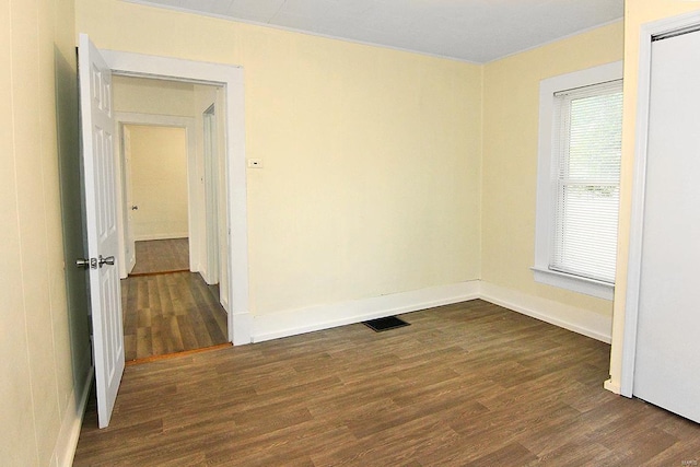 spare room with dark wood-type flooring