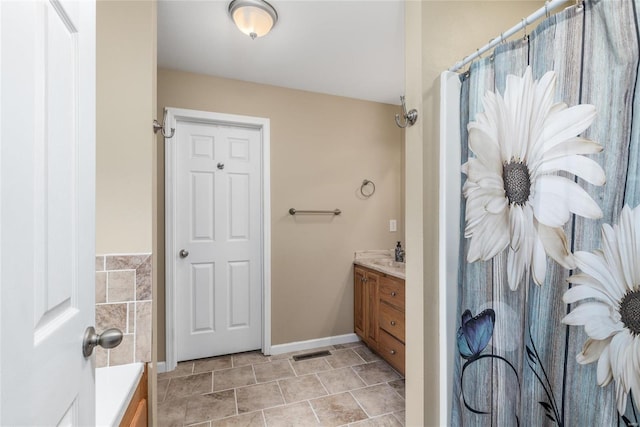 bathroom with vanity and a bathtub