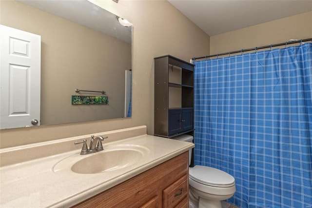 bathroom featuring vanity, curtained shower, and toilet