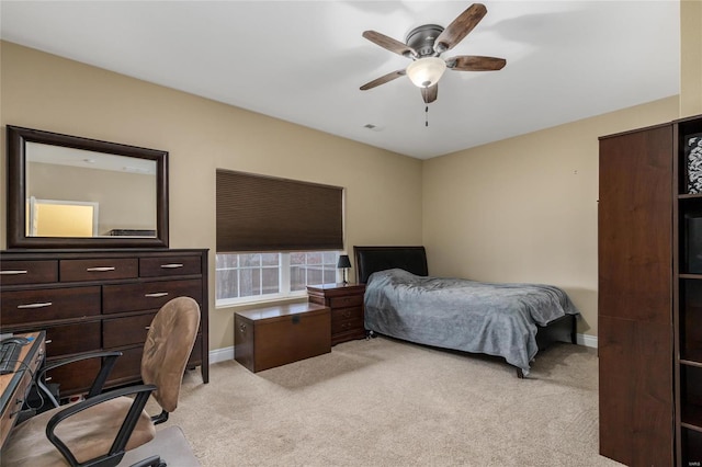 bedroom featuring ceiling fan and light carpet