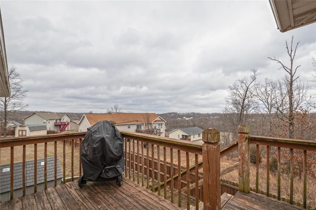 wooden deck with a grill