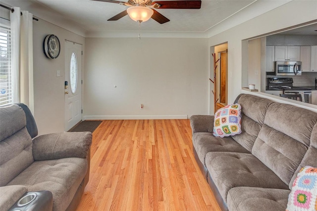 living room with wood-type flooring and ceiling fan