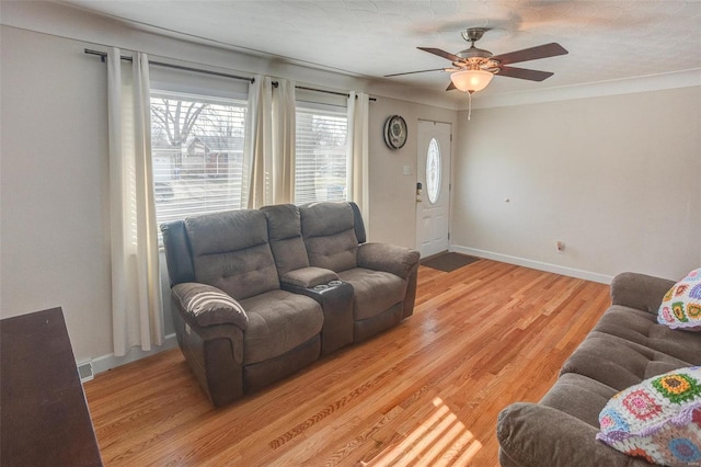 living room featuring wood-type flooring and ceiling fan