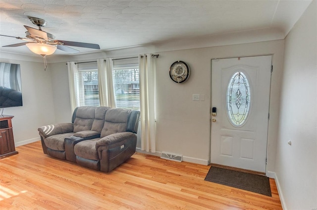 entryway with ceiling fan and light hardwood / wood-style flooring