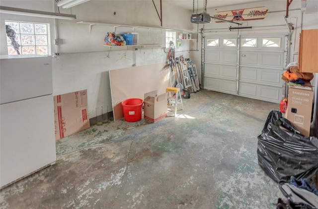 garage with a garage door opener and white fridge