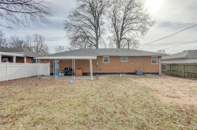 rear view of property featuring a yard, central AC, and a patio