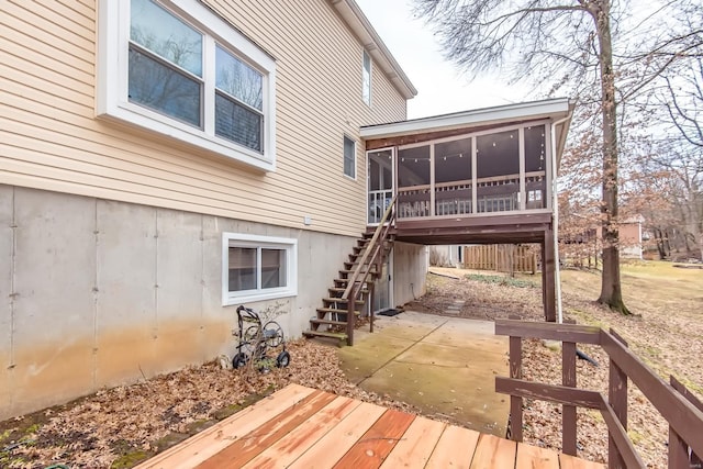 deck with a sunroom and a patio area