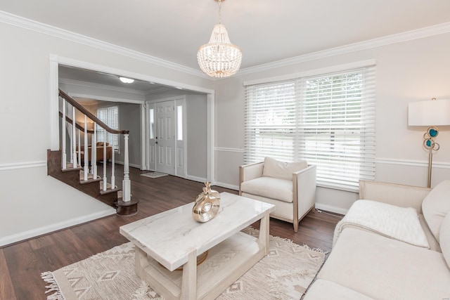 living room featuring ornamental molding, dark hardwood / wood-style floors, and an inviting chandelier