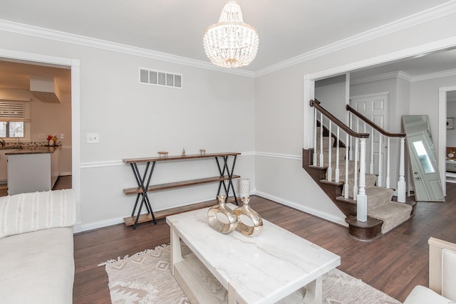 living room featuring crown molding, dark hardwood / wood-style floors, and a notable chandelier