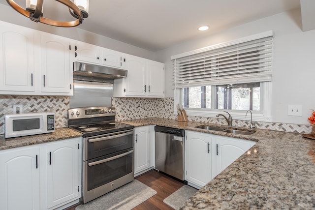 kitchen featuring white cabinetry, stainless steel appliances, sink, and dark stone countertops