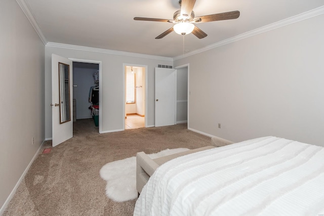 bedroom with ensuite bathroom, ornamental molding, a spacious closet, light carpet, and a closet