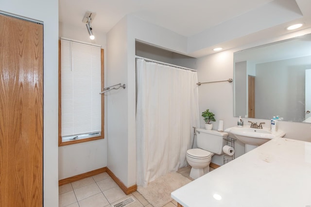 bathroom with toilet and tile patterned flooring