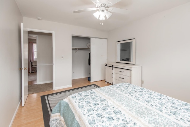 bedroom with ceiling fan, a closet, and light hardwood / wood-style flooring