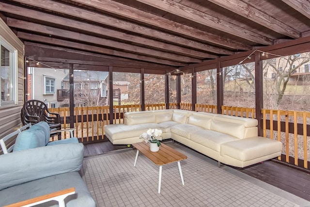 sunroom featuring beamed ceiling