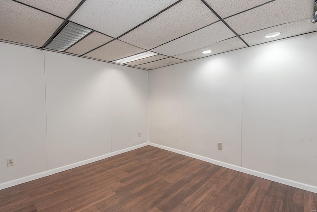 spare room with a paneled ceiling and hardwood / wood-style floors