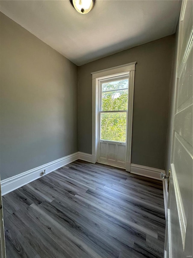 unfurnished room featuring dark hardwood / wood-style flooring