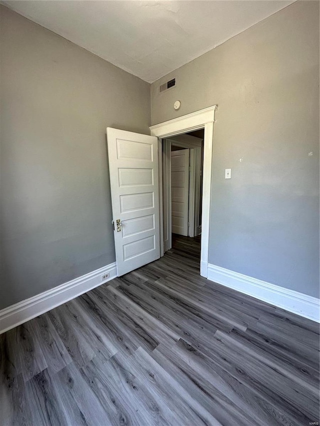 spare room featuring dark hardwood / wood-style floors