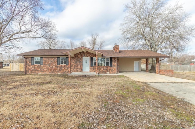 ranch-style house featuring a front lawn and a carport