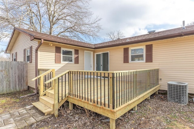 back of house with a wooden deck and central air condition unit