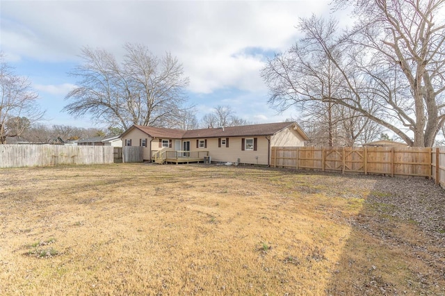 back of house with a yard and a deck