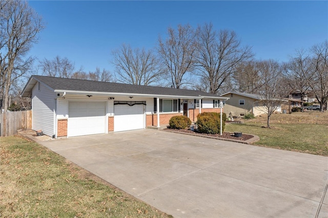 ranch-style home with a garage, driveway, fence, a front yard, and brick siding