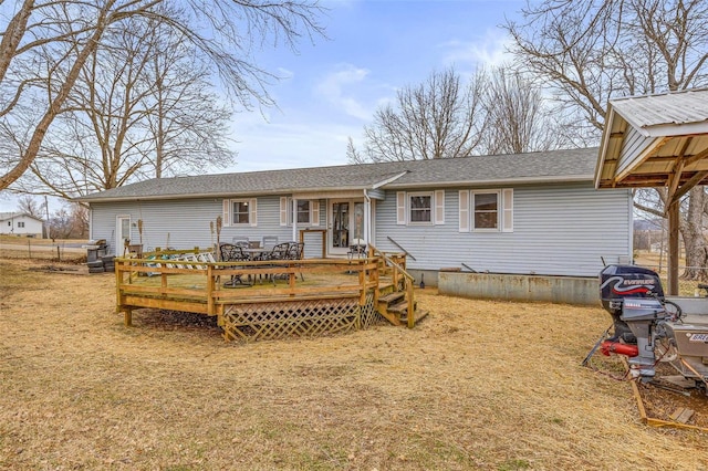 view of front of home with a front lawn and a deck