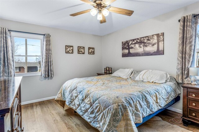 bedroom with hardwood / wood-style flooring and ceiling fan