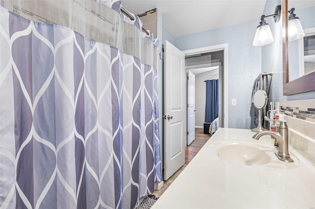 bathroom featuring tasteful backsplash and vanity