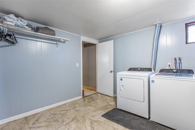 washroom featuring independent washer and dryer and a textured ceiling