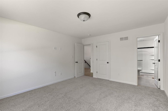 unfurnished bedroom with carpet and ensuite bath