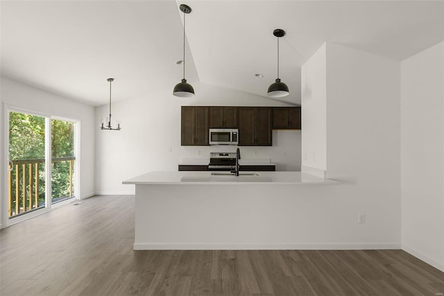 kitchen with stainless steel appliances, dark brown cabinetry, wood-type flooring, vaulted ceiling, and kitchen peninsula