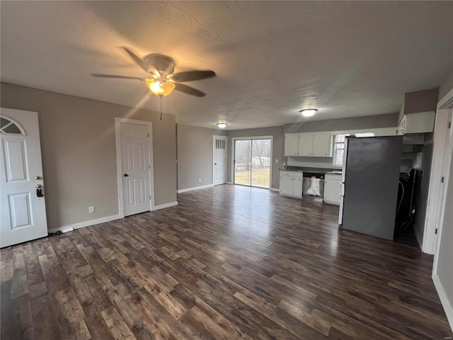 unfurnished living room with dark wood-type flooring, ceiling fan, and a textured ceiling