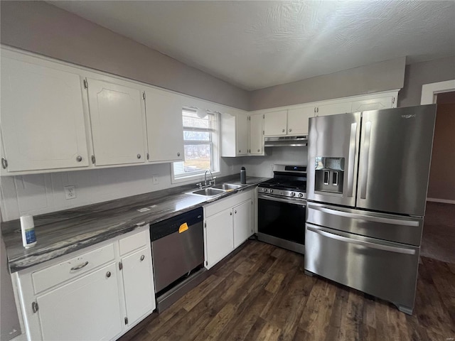 kitchen with sink, dark wood-type flooring, white cabinetry, stainless steel appliances, and a textured ceiling