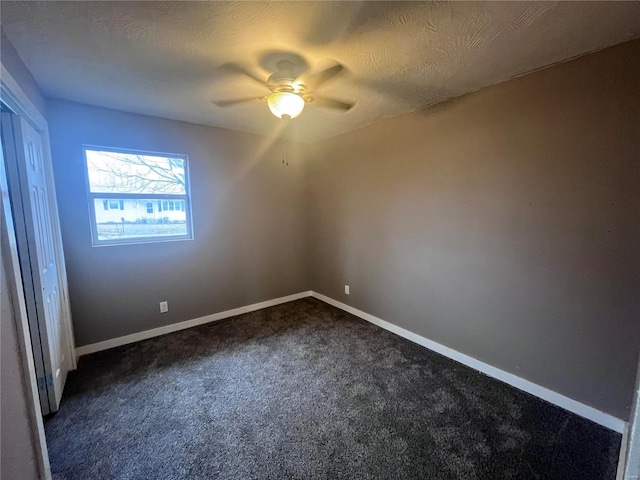 carpeted empty room with a textured ceiling and ceiling fan