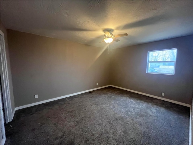 bonus room with dark carpet, a textured ceiling, and ceiling fan