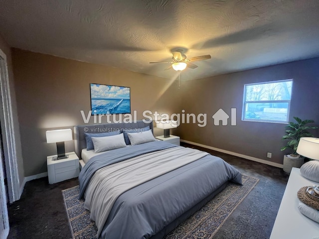 bedroom featuring ceiling fan, a textured ceiling, and dark colored carpet