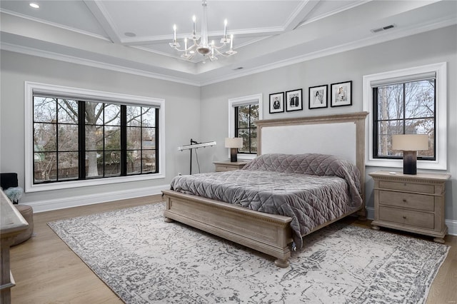 bedroom featuring light wood-type flooring, multiple windows, visible vents, and a chandelier