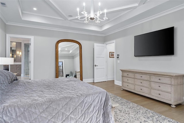 bedroom featuring a notable chandelier, crown molding, a raised ceiling, and wood finished floors