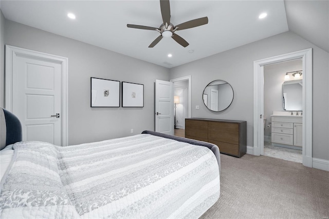 bedroom featuring recessed lighting, light colored carpet, ensuite bathroom, ceiling fan, and baseboards