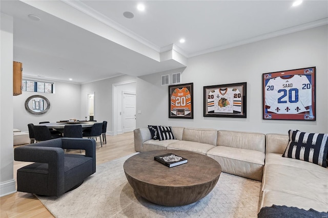 living area with recessed lighting, baseboards, crown molding, and light wood finished floors