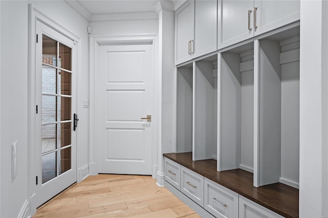 mudroom featuring light wood-style floors and crown molding