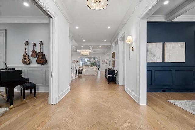 foyer entrance with an inviting chandelier, crown molding, a decorative wall, beam ceiling, and recessed lighting