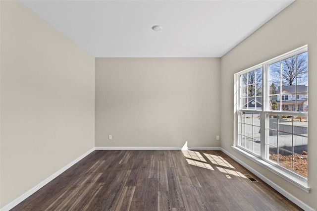 spare room featuring dark wood-type flooring